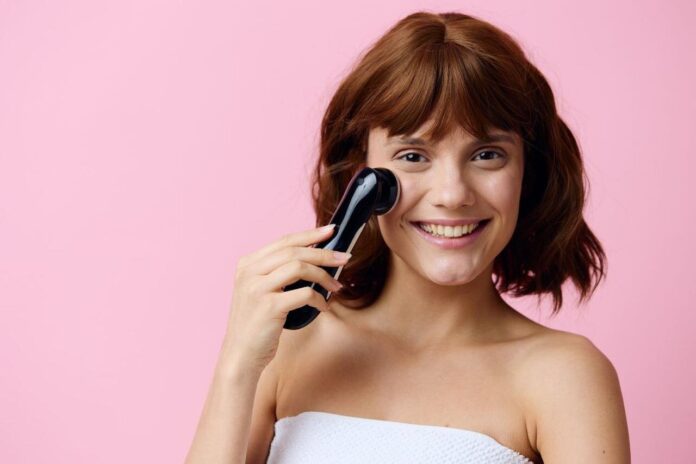 Женщина использует футуристический косметический гаджет в стиле киберпанк